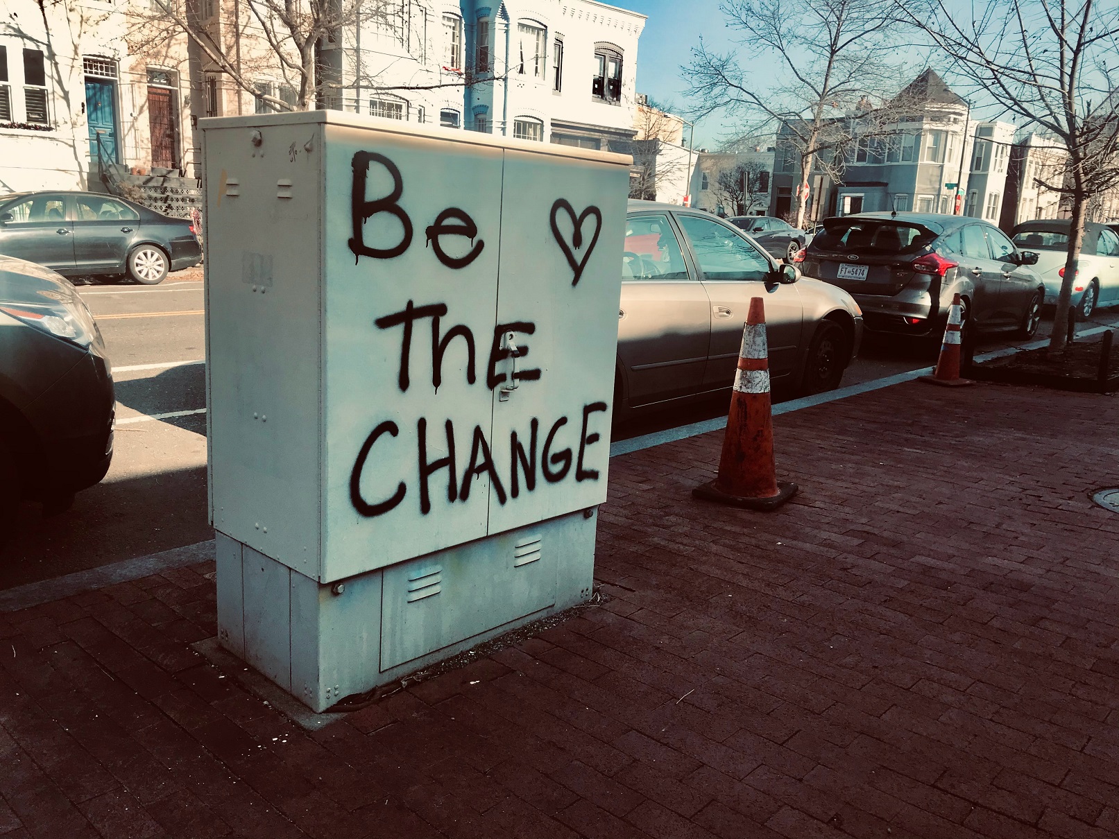 sign that says be the change and make a positive impact